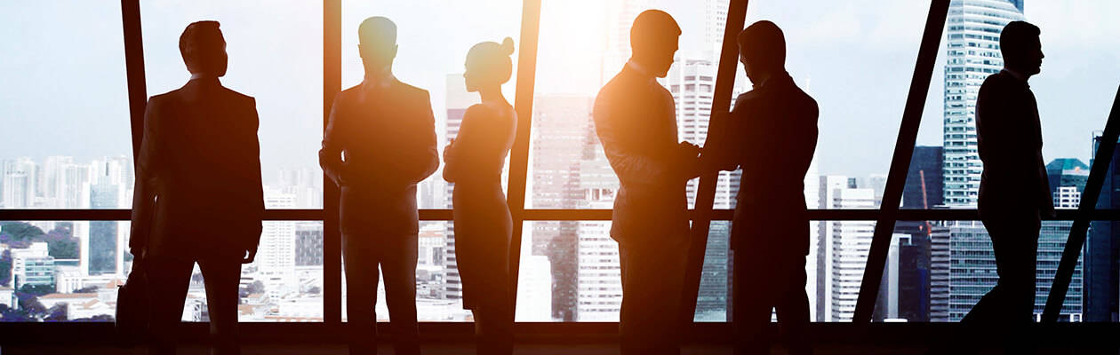 group of lawyers in silhouette in front of a a glass wall